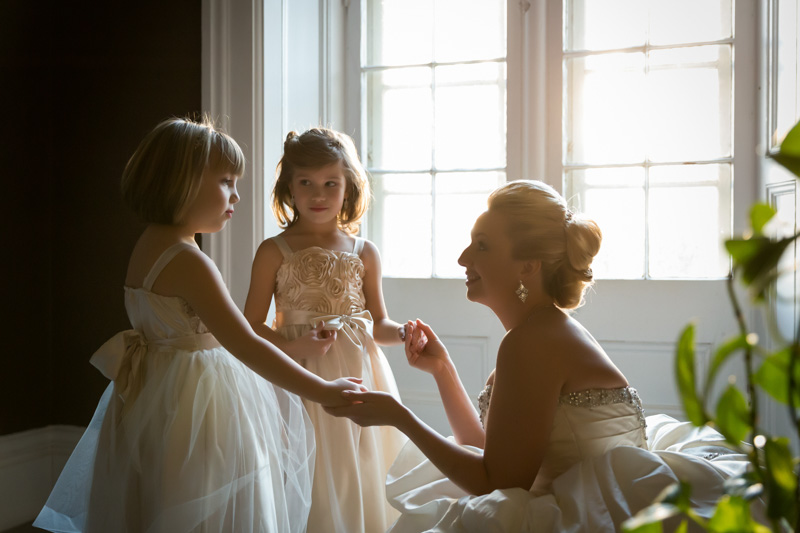 Bride holding daughters' hands