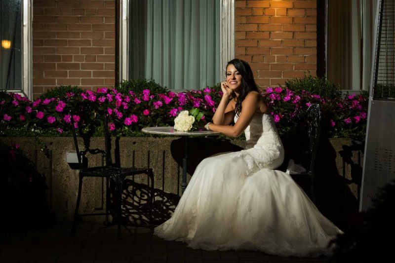 Bride sitting down showing dress