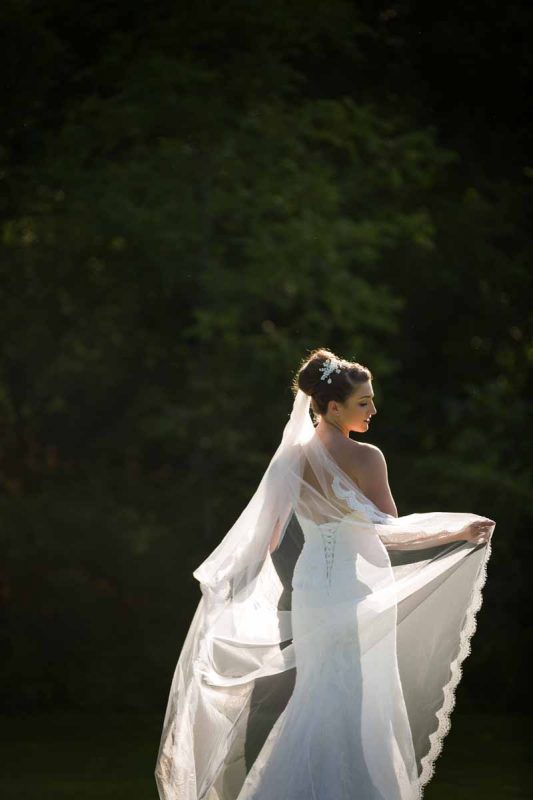 Bride showing off veil