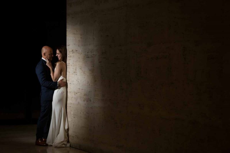 Couple against a wall during reception