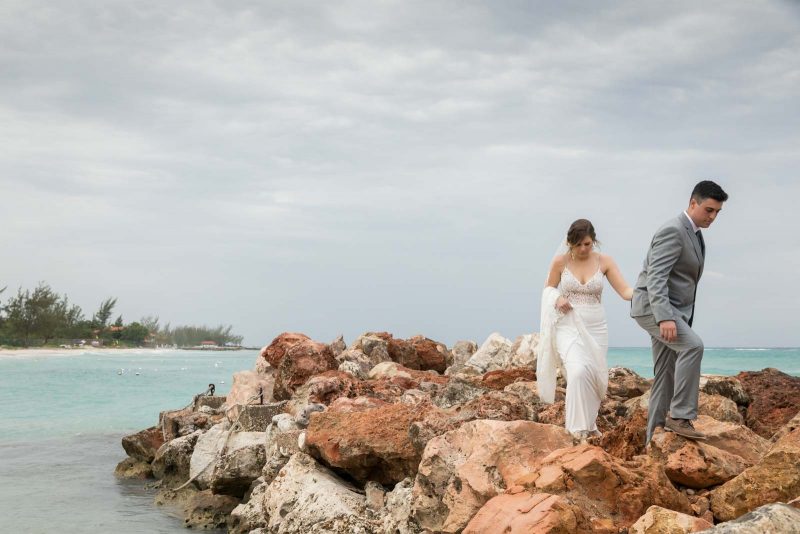 Newlyweds walking on rocks