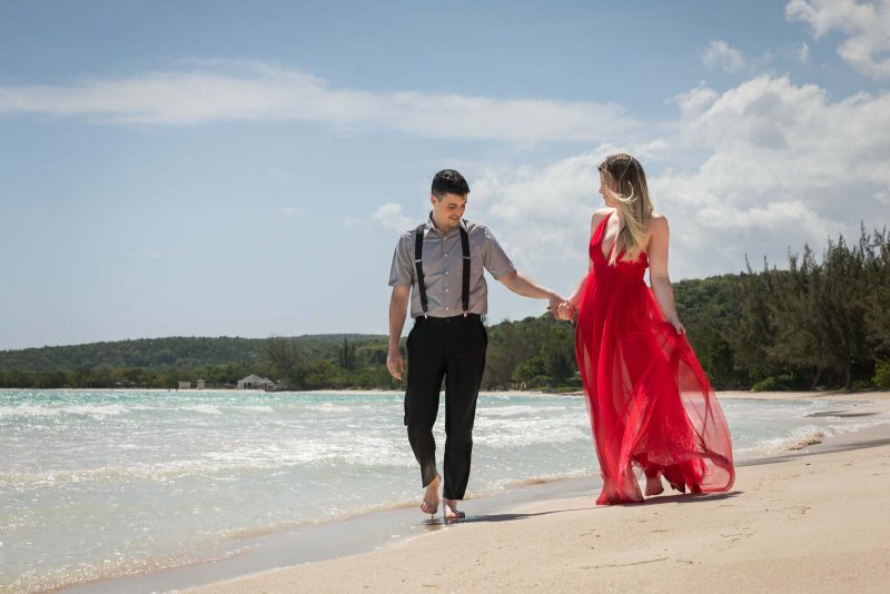 Bride and groom walking on beach