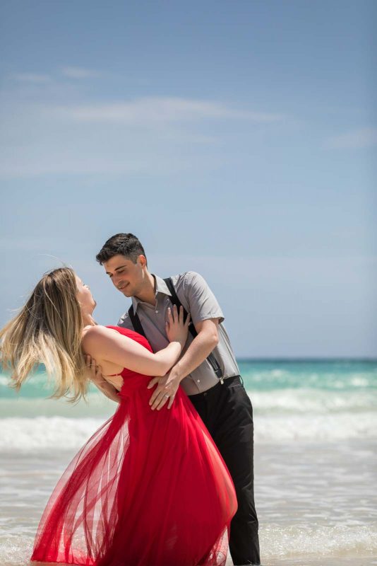 Newlyweds dancing on beach