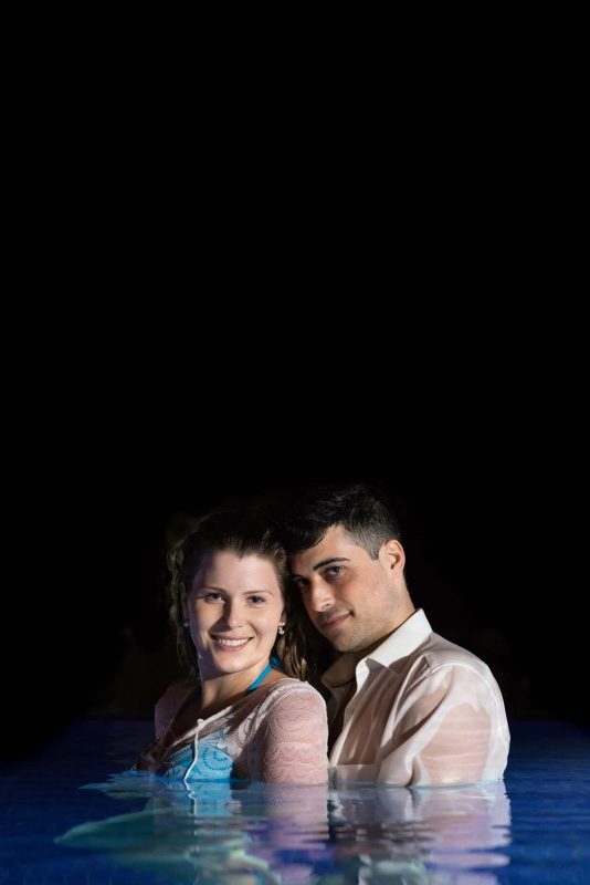 Bride and groom portrait in the swimming pool at night