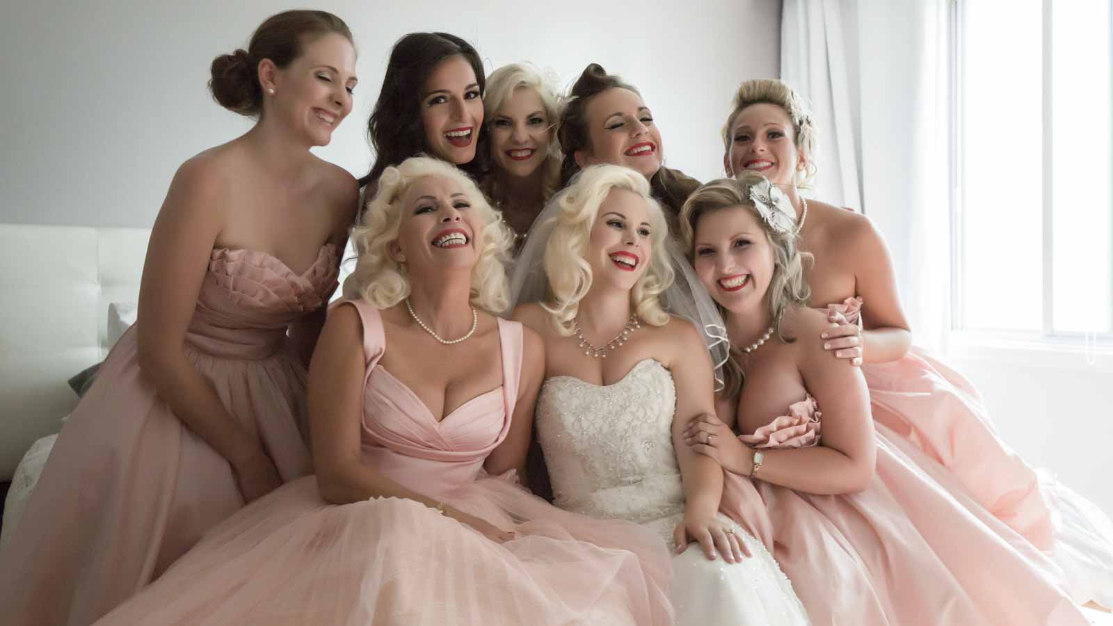 Bridesmaids taking group picture during preparation