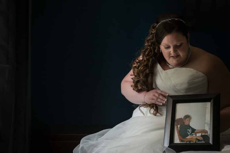 Bride holding mom's photo