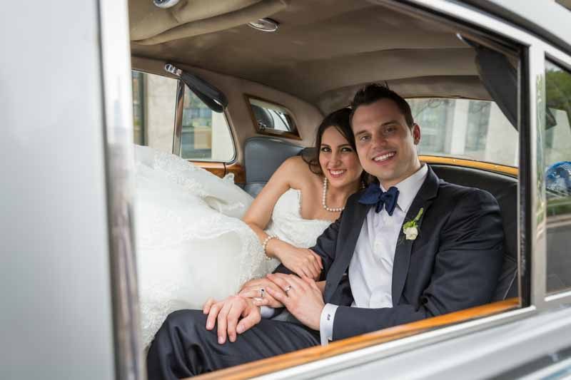 Bride and groom inside limousine