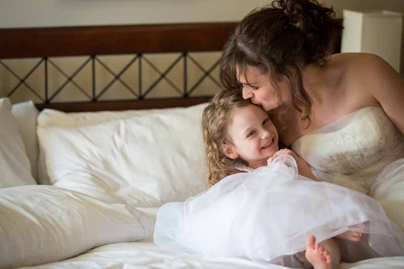 Bride kissing daughter