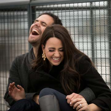 Couple laughing during engagement at Old Port Montreal